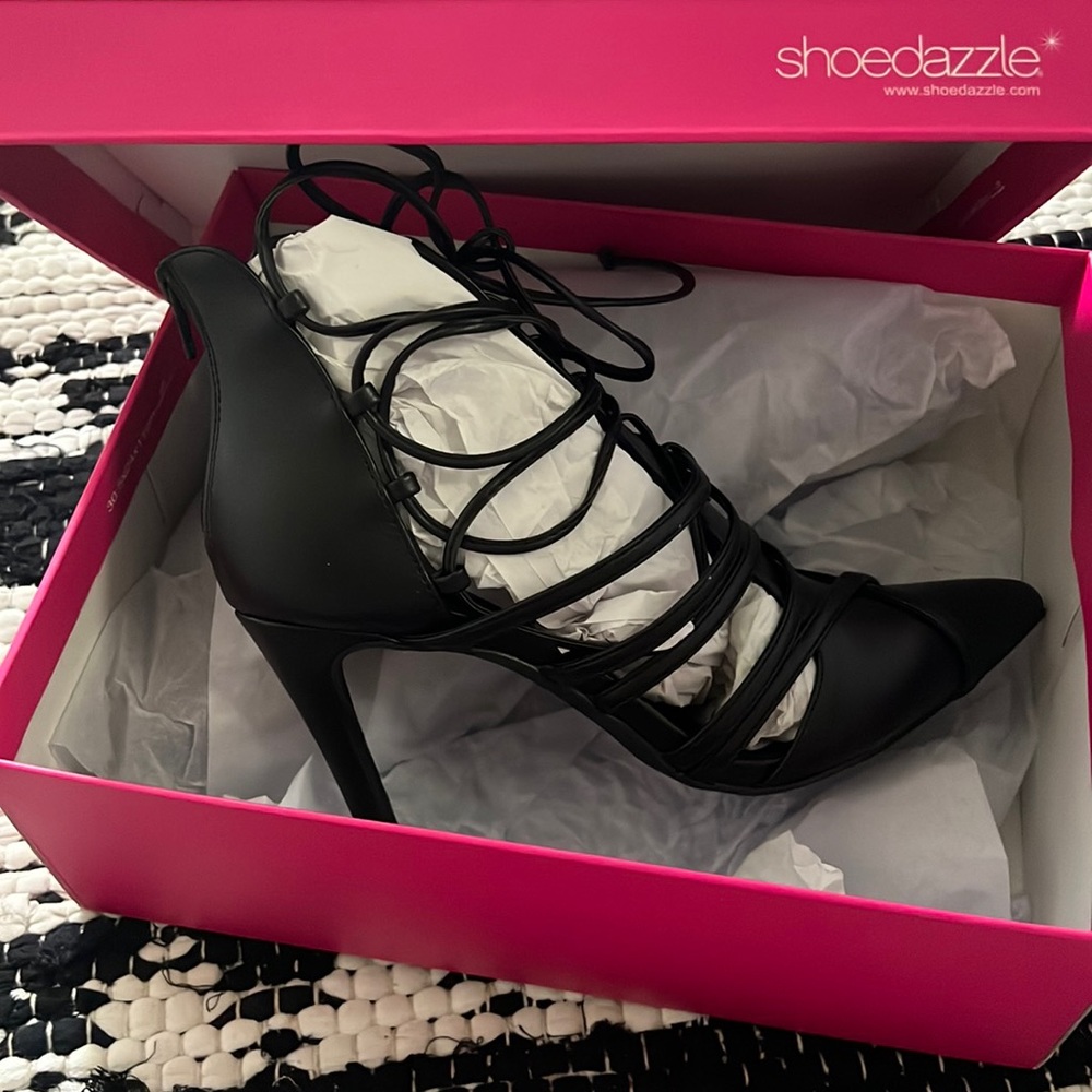 Black tie up pumps in a size 8.5. Never worn. Still has stuffing.